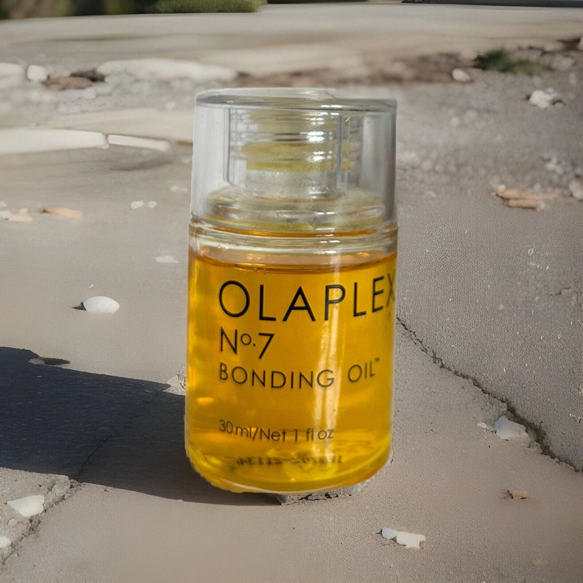 OLAPLEX No.7 Bonding Oil 30ml glass bottle lifestyle shot outdoors